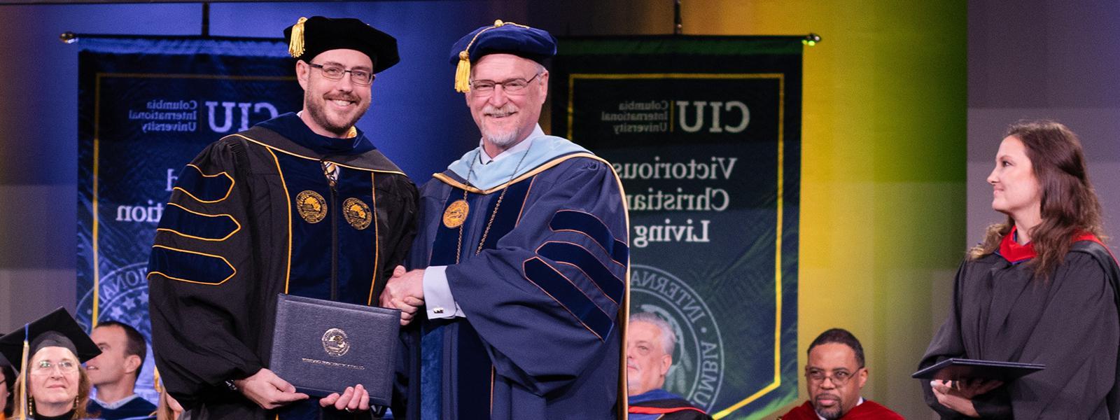 Doug Smith receives his doctorate from CIU Executive Vice President Dr. Rick Christman.
